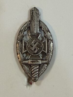 NSKOV membership badge showing sword, oak-leaf wreath and central emblem