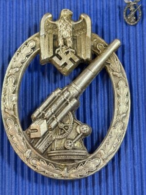 Army Flak Badge reverse showing hinged pin fitting, retaining catch and patina.