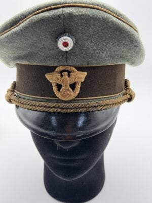 Police general visor cap by Marie Slama & Sohn, Vienna, size 56. Gold braid piping, gilt eagle and marked interior. No fluorescence under UV light.